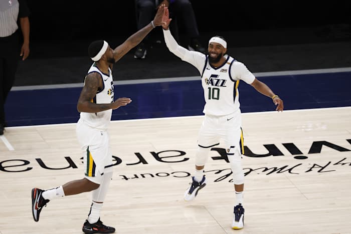 Mike Conley (10) celebrates with teammate Royce O'Neale (23) 